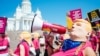 FINLAND -- Protester of the #ResistGag movement wearing masks of US President Donald Trump stage a protest at the Senate square in Helsinki, Finland on July 16, 2018, to support women's rights ahead of the meeting between US President and his Russian coun